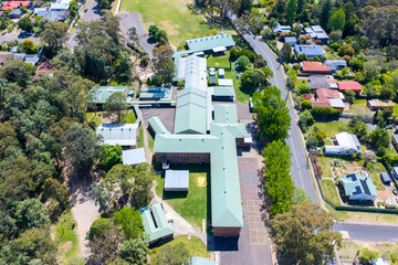 Drone aerial photograph of Springwood Public School which is located amongst lush foliage in the...