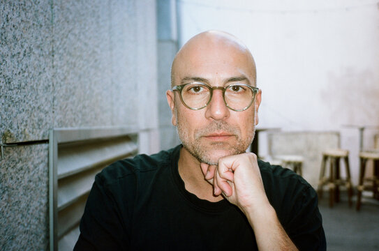 Thoughtful Man With Glass Sitting outdoors 