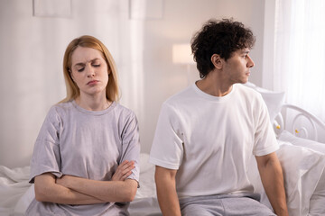 Couples who are angry at each other, fighting in bed, feeling frustrated, sad, divorce or...