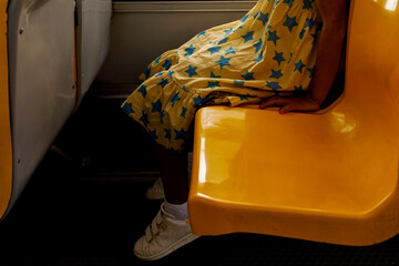 Child Sitting Quietly on a Bright Yellow Bus Seat 