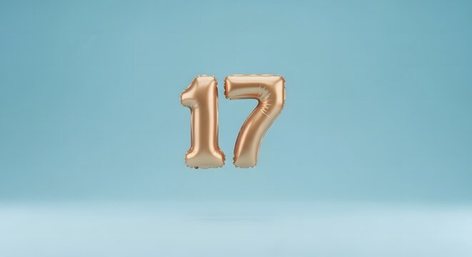 Dynamic 3D artwork showing the number seventeen as a reflective gold foil balloon, set against a smooth, bright blue background, perfect for age and milestone events