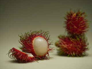 The delicious rambutan fruit, showing spiky red skin and white flesh