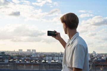 Young Person Capturing a Beautiful City Skyline During Sunset