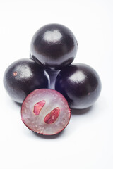 Cut and whole jabuticaba, exotic tropical fruit from Brazil