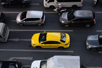 Yellow taxi among traffic in Bangkok, Thailand