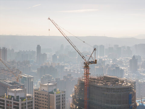 Construction crane above modern city skyline