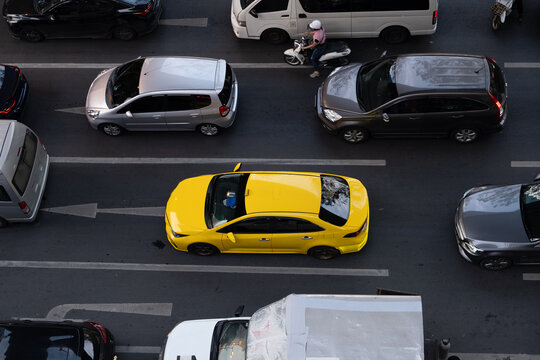 Yellow taxi among traffic in Bangkok, Thailand