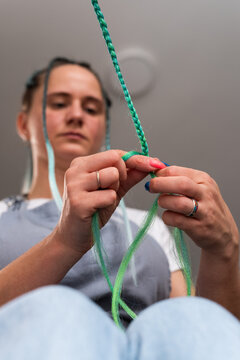 Woman braiding hair extensions