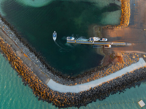 Coastal boatramp guarded by a rocky breakwater