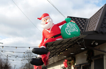 Inflatable Santa Claus on the roof of the store