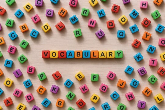 Colorful Letter Cubes Spelling Vocabulary on Beige Background for Education, Language Learning and Creative Writing
