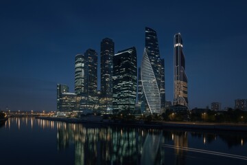 Obraz premium Modern Cityscape at Night Reflecting on River, Featuring Skyscrapers and Urban Illumination