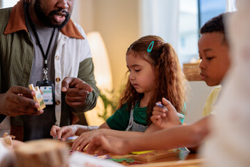 Teacher guides children in a learning activity.
