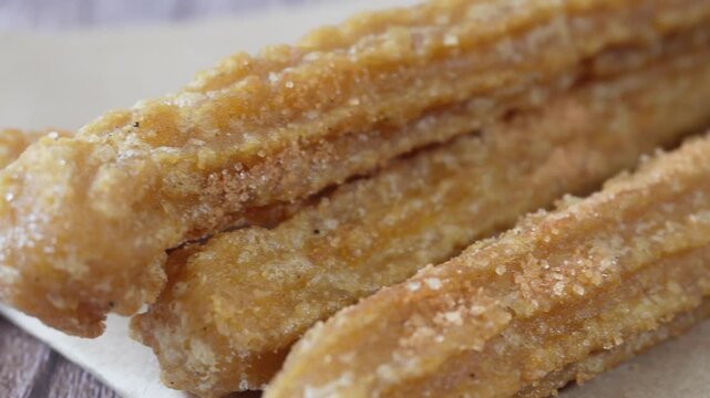 Pan to a close-up of a group of churros. Mexican food