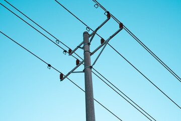 Low angle view of power lines under blue sky