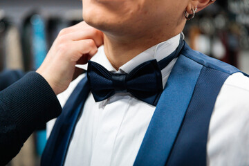 Close-Up of Bow Tie Adjustment During Formalwear Fitting