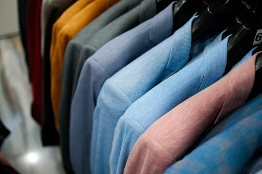 Colorful suit jackets hanging in boutique