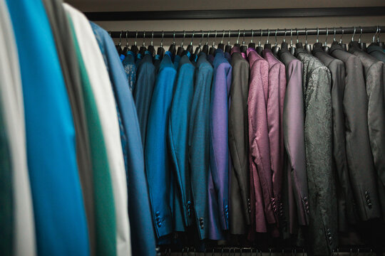 Colorful tailored jackets hanging in boutique rack