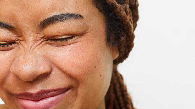 Close-up of Latina woman smiling with eyes closed and wet skin