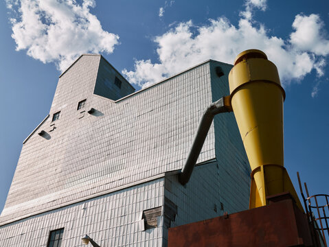 Grain elevator with industrial yellow chute