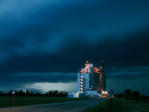Potash plant illuminated under stormy night sky