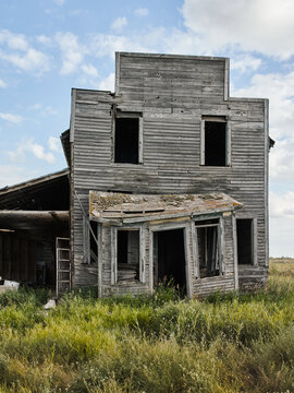Abandoned wooden house in ghost town prairie