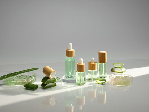 Aloe vera skincare products in glass bottles with bamboo caps