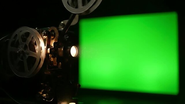 Dark Room Ambiance with old cinema projector displays green screen in a you can see parts of the film and his wheels that turn distortion, overlay, glitch, static noise, scan lines on black