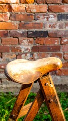 Used saddle on wood stand