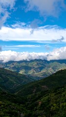 Vast mountain valleys beneath blue sky and clouds!