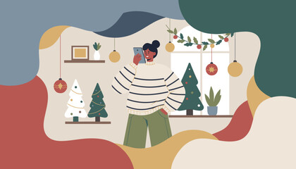 Modern woman chatting on smartphone in a festive room with abstract Christmas decorations
