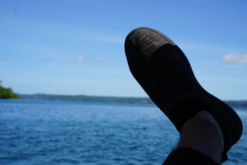 Feet relaxing with a beautiful lake view in the background