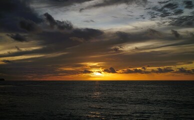 The beautiful sunset over the ocean at dusk gives a calm and peaceful impression.