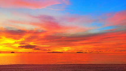 Sea sunset, tropical island beach sunrise, beautiful ocean panorama landscape, colorful red orange pink yellow sky clouds over water, golden sun light, summer holidays, travel