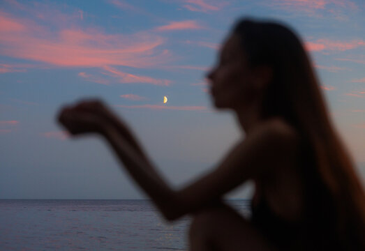 Pink Dusk With Crescent Moon and Woman Silhouette