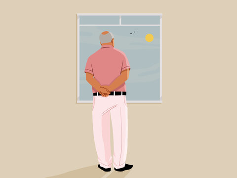 Senior man looking out window at sunny sky with birds flying