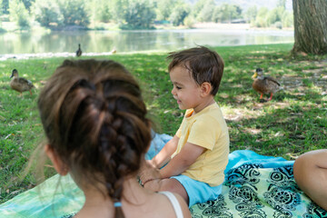 Boy smiling near ducks