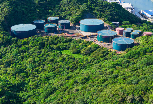 Oil storage tanks in industrial facility among hills