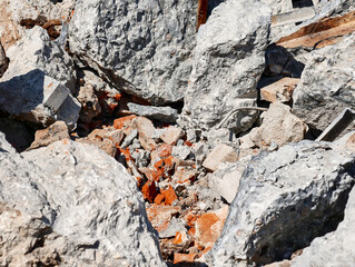Rubble and debris scattered in a construction site after demolition activity on a sunny day in...