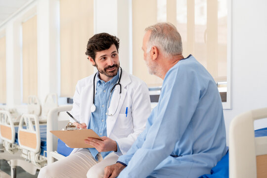 Doctor visiting patient in hospital room taking notes
