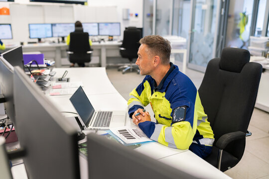 Worker Focused on Task at Modern Control Room