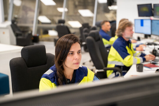 Team of Operators Working in a Control Room 