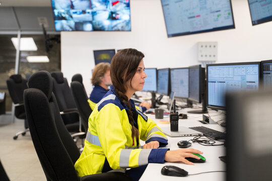 Operator Working At Desk In A Control Room 