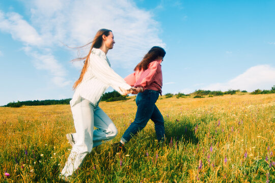 Women Running Hand in Hand