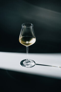 Glass of white wine in dramatic lighting