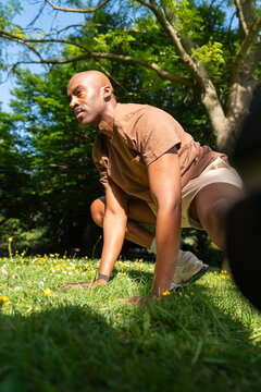Black man practicing yoga,meditation in the park London