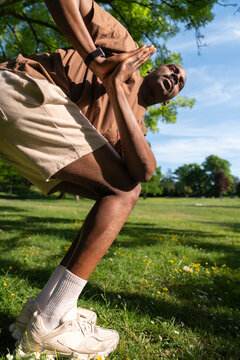 Black Man in a Twisted Lunge Yoga position in a London Park