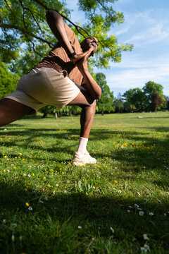 Handsome black man executing a Yoga pose in a Lunge 