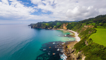 Stunning aerial view of a rugged coastline featuring lush green cliffs meeting a bright turquoise sea and a secluded pebble beach. Perfect European coastal escape.