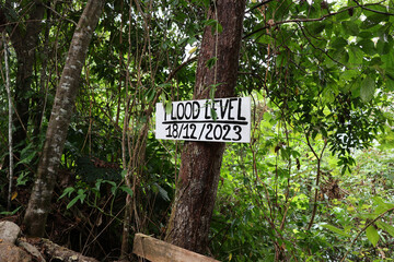 Flood Level 18/12/2023 sign attached to a tree next to the Daintree River in Queensland, Australia